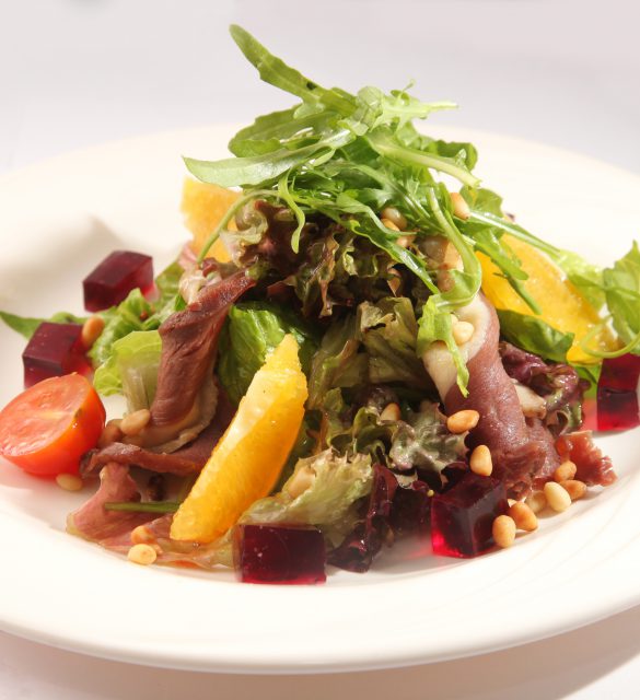 Salad with roast beef and orange on plate