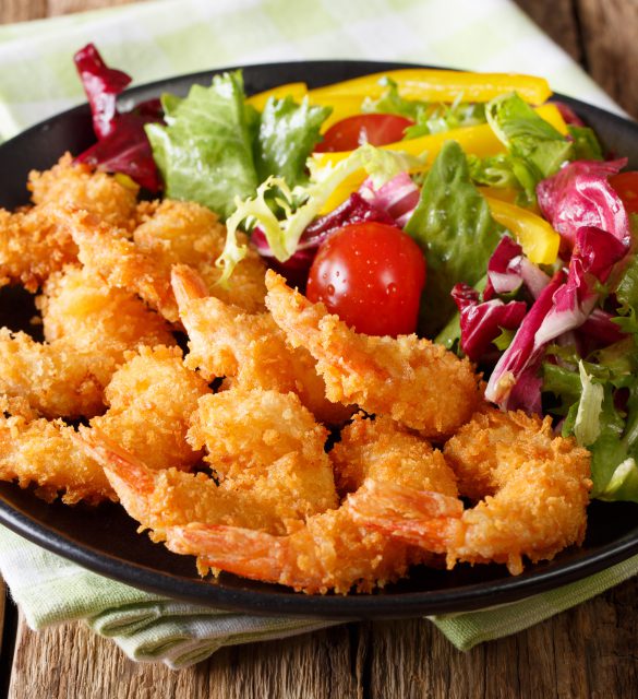 Fried shrimps tempura and fresh salad close-up on a plate. horizontal