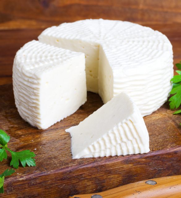 Soft salty cheese on a wooden table Soft salty cheese on a wooden table