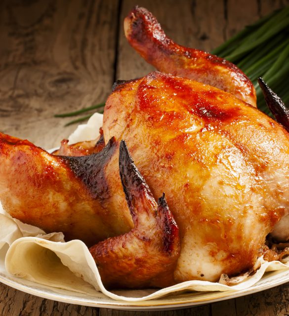 baked chicken on a plate with pita bread