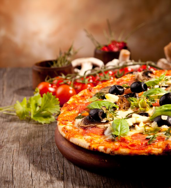 Delicious fresh pizza served on wooden table
