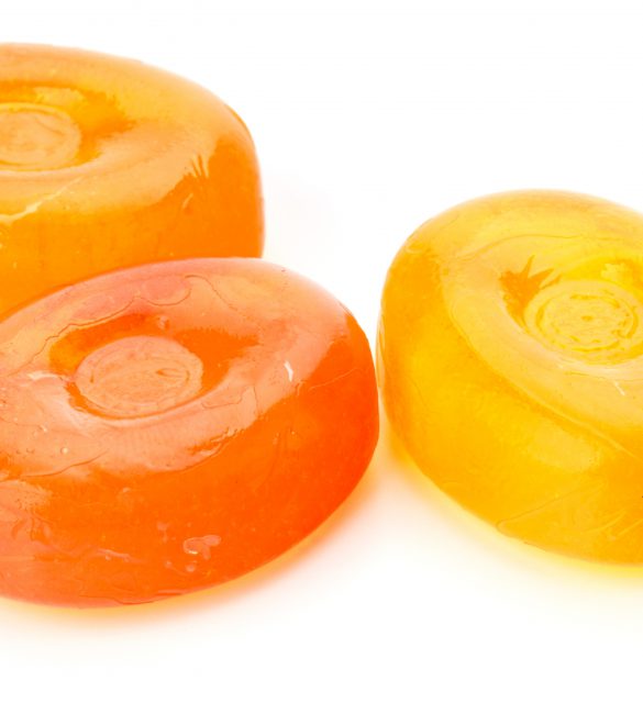 Three colorful fruit hard sugar candies, boiled sweeties or sugar plums isolated on white background cutout Three colorful fruit hard sugar candies, boiled sweeties or sugar plums isolated on white background cutout