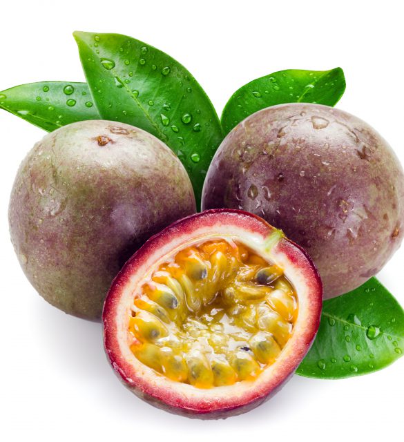 Wet passion fruits with leaves isolated on white