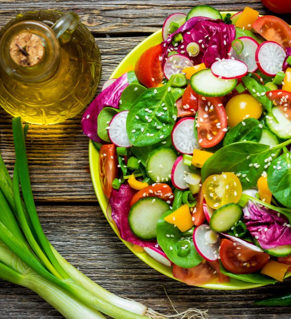 Fresh vegetable salad on wooden background