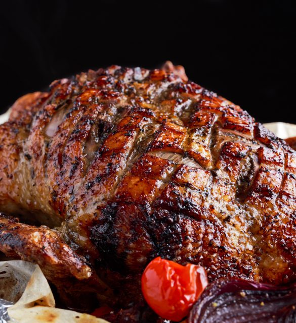 Duck roast with baked vegetables close up.