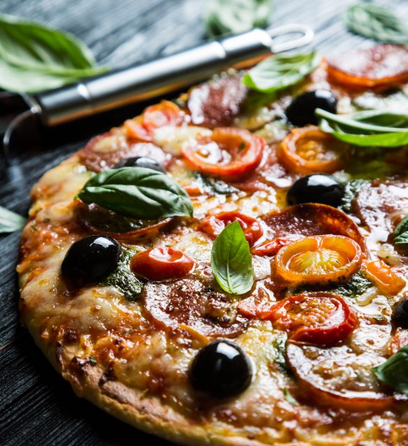 Pizza with salami, olives and basil Pizza with salami, olives and basil