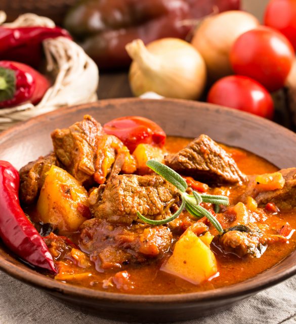 Hungarian goulash in plate Goulash in ceramic plate. Traditional hungarian meal.