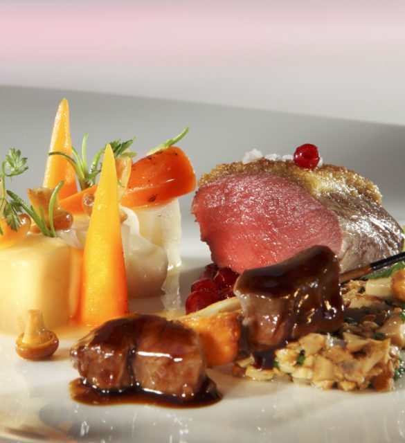 Saddle of venison on a bed of chanterelles with a side of vegetables Saddle of venison on a bed of chanterelles with a side of vegetables